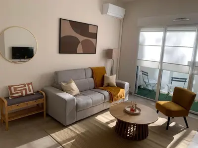 a living room with a couch and a table at Nice virgil Barel in Nice
