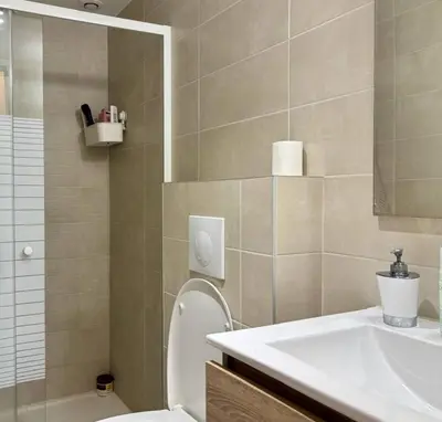a bathroom with a sink and a toilet and a mirror at Nice Signature Delille in Nice