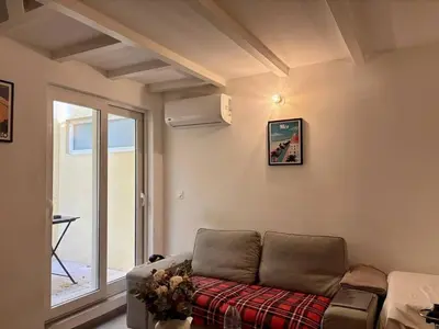 a living room with a couch and a window at Nice Signature Delille in Nice