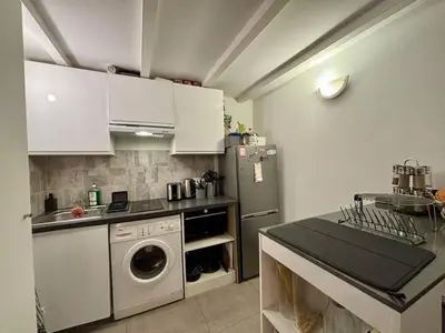 a kitchen with a washing machine and a refrigerator at Nice Signature Delille in Nice