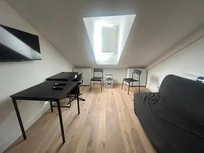 a room with a desk and chairs in a attic at Nice Signature Assalit Studio in Nice
