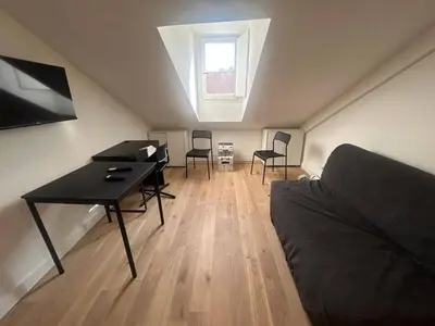 a room with a desk and chairs in a attic at Nice Signature Assalit Studio in Nice