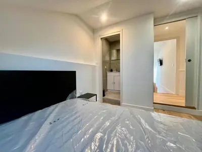 a bedroom with a large bed and a hallway at Nice Signature Assalit 2P in Nice