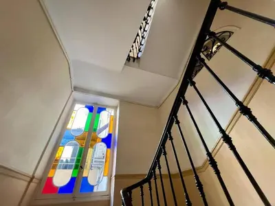 a stained glass window in a stair case at Nice Signature Assalit 2P in Nice