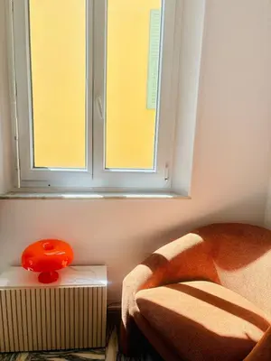 a room with a window and a chair and a table at Centre ville-vieille ville-promenade des Anglais in Nice