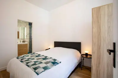a bedroom with a white bed and a mirror at ICONIC AP4460 By Riviera Holiday Homes in Nice