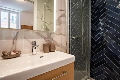 a bathroom with a sink and a mirror and a shower at ICONIC AP4460 By Riviera Holiday Homes in Nice