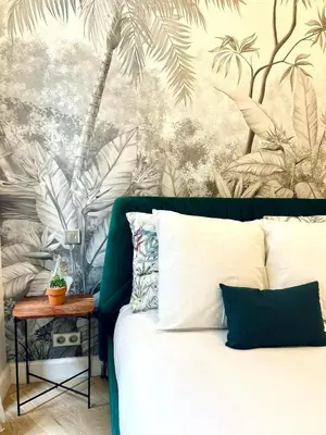a bedroom with a bed with a mural of palm trees at Old Town Vibes - 5min to Sea - AC & Breakfast in Nice