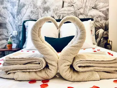a bed with towels shaped like swans on it at Old Town Vibes - 5min to Sea - AC & Breakfast in Nice