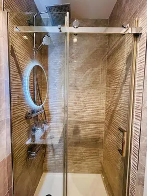 a shower with a glass door in a bathroom at Old Town Vibes - 5min to Sea - AC & Breakfast in Nice