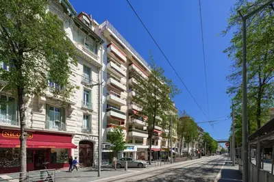 a street in a city with a building at Studio Malaussena - Welkeys in Nice