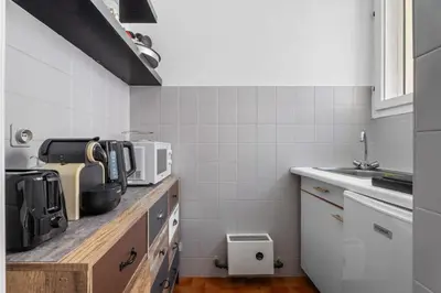 a kitchen with a counter top with a microwave at Studio Malaussena - Welkeys in Nice
