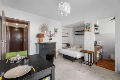 a bathroom with a bed and a sink in a room at Studio Malaussena - Welkeys in Nice
