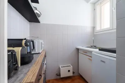 a kitchen with a counter top with a microwave at Studio Malaussena - Welkeys in Nice