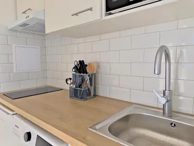a kitchen counter with a sink and a counter top at Panoramic Sea View Studio in Cagnes-sur-Mer