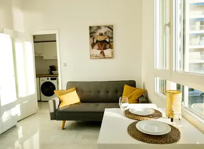 a living room with a couch and a table at Panoramic Sea View Studio in Cagnes-sur-Mer