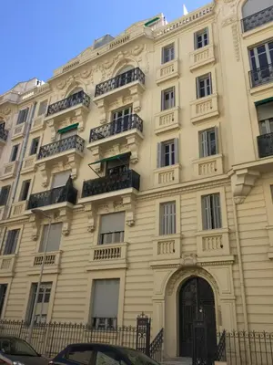 a large white building with balconies on it at Lumineux Studio dernier étage avec terrasse, proche mer in Nice