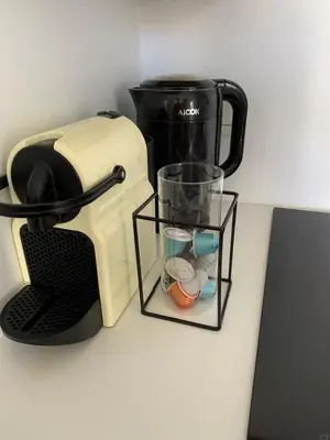 a toaster with a glass holder next to a cup at Lumineux Studio dernier étage avec terrasse, proche mer in Nice
