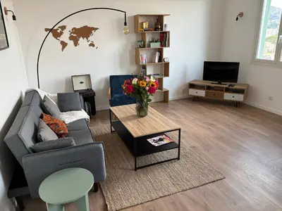 a living room with a couch and a table at Magnifique 2 pièces in Nice