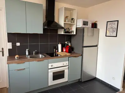 a kitchen with a white refrigerator and a sink at Magnifique 2 pièces in Nice
