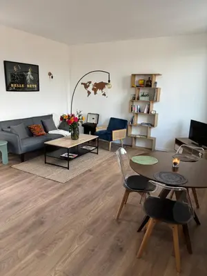 a living room with a couch and a table at Magnifique 2 pièces in Nice