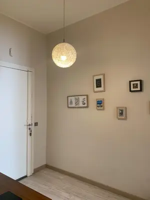 a room with a white wall with pictures on it at Port de nice in Nice