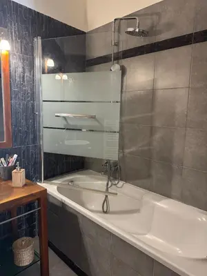 a bathroom with a bath tub and a sink at Port de nice in Nice