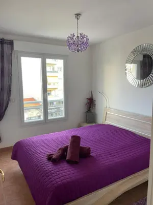 a purple bed with a stuffed animal on it at Comfy 2 min to Beach - AC in Nice