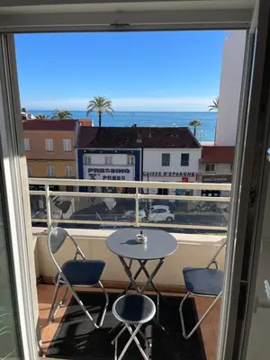 a balcony with a table and chairs and a view of the ocean at Comfy 2 min to Beach - AC in Nice