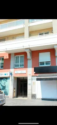 a red and white building with a sign on it at Comfy 2 min to Beach - AC in Nice