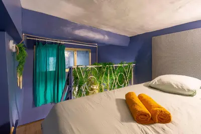 a blue bedroom with a bed with towels on it at Boho Chic Apartment in Old Town in Nice