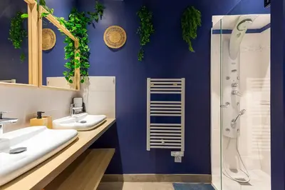 a bathroom with two sinks and a shower at Boho Chic Apartment in Old Town in Nice