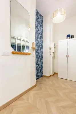 a room with white walls and a mirror on the wall at Boho Chic Apartment in Old Town in Nice