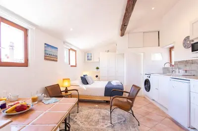 a kitchen and living room with a bed and a table at #5 Eagle Nest 5mins walk of the Sea AC Wifi Old town in Nice