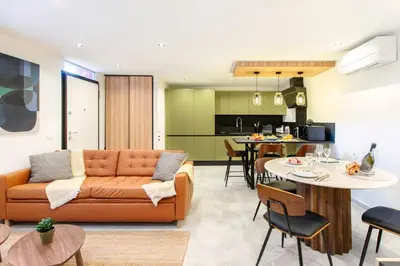 a living room with a couch and a table at #45 Quiet chic 5mins walk to port and beach AC Wifi in Villefranche-sur-Mer