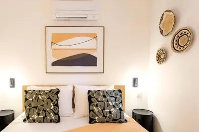 a bedroom with a bed and a picture on the wall at #45 Quiet chic 5mins walk to port and beach AC Wifi in Villefranche-sur-Mer