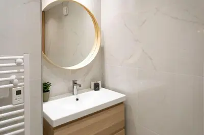 a bathroom with a white sink and a mirror at #45 Quiet chic 5mins walk to port and beach AC Wifi in Villefranche-sur-Mer