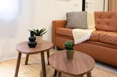 a living room with two tables and a couch at #45 Quiet chic 5mins walk to port and beach AC Wifi in Villefranche-sur-Mer