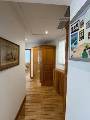 a hallway of a house with wooden floors at Seaside Serenity, Portside Apartment in Èze