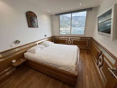 a bedroom with a bed in a room with a window at Seaside Serenity, Portside Apartment in Èze
