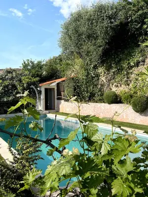 a swimming pool with a house in the background at Cabana 12 m2 in Nice