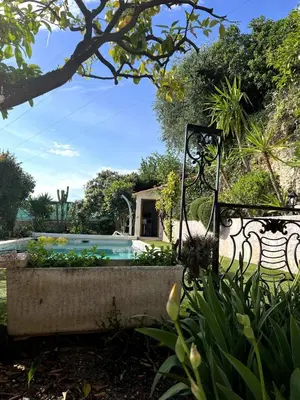 a garden with a fence and a swimming pool at Cabana 12 m2 in Nice
