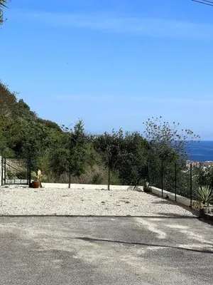 a beach with a fence and the ocean in the background at Cabana 12 m2 in Nice