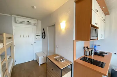 a small kitchen with a sink and a stove at Lovely 4-person studio - pool and sea in Cros-de-Cagnes