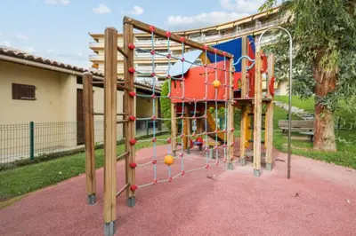 a playground with a play equipment in a park at Lovely 4-person studio - pool and sea in Cros-de-Cagnes