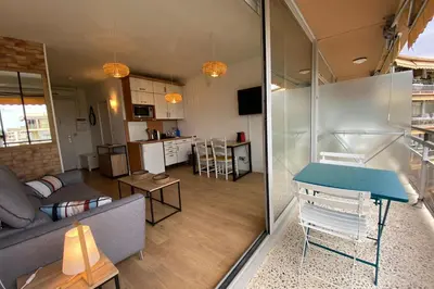 a living room with a couch and a table at Lovely 4-person studio - pool and sea in Cros-de-Cagnes