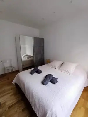 a bedroom with a white bed with two towels on it at Superbe appartement, aperçu mer, Negresco-centre in Nice
