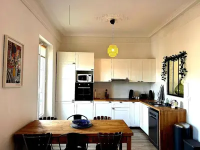 a white house with black windows and a fence at Charming Flat in Nice Villa in Nice