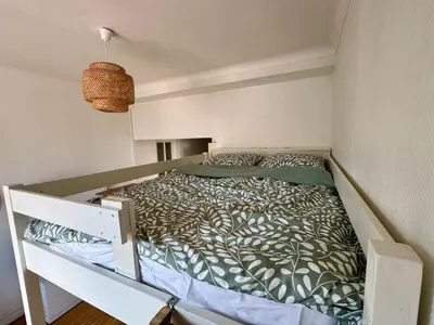 a large bed in a room with a bed frame at Liberation Cozy Studio in Nice in Nice