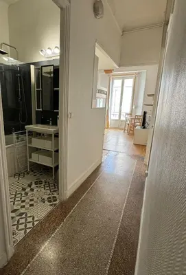 a room with a hallway with a sink and a mirror at Liberation Cozy Studio in Nice in Nice